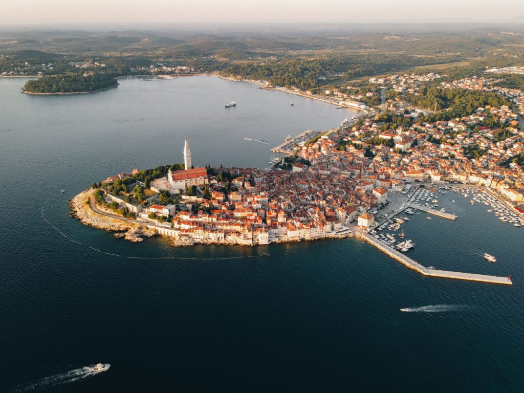 Stunning aerial view of Rovinj's historic peninsula with red rooftops by the Adriatic Sea in Croatia.